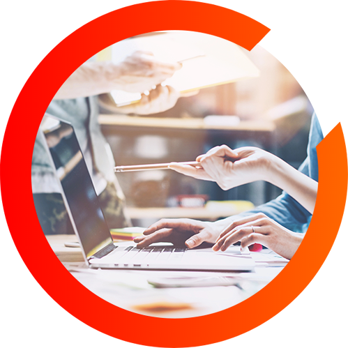 A woman points at her computer while her co-workers types in a three quarter orange circle.