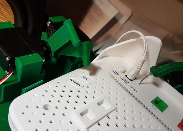 An up-close shot of a modem plugged into power.